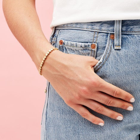 Bracelet with 18 gold stars on silver thread cord