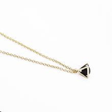 Gold necklace with a triangular caged charm