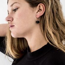 Gold hoop earrings with black disk beads