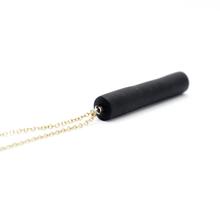 Gold necklace with a black bar pendant