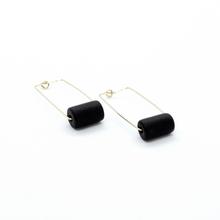 Gold rectangular earrings with a black bead