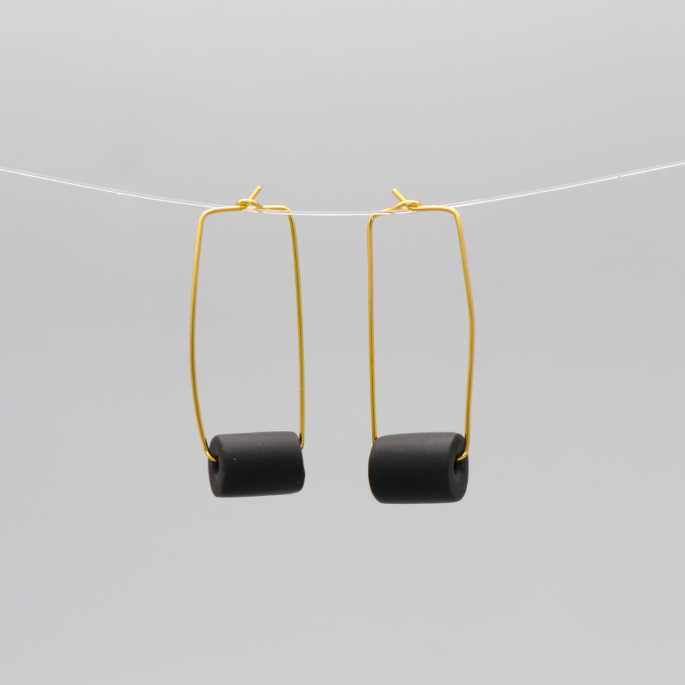 Gold rectangular earrings with a black bead