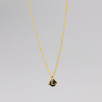 Gold necklace with a triangular caged charm
