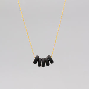 Gold necklace with black disk beads